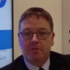 Man in a suit at a conference