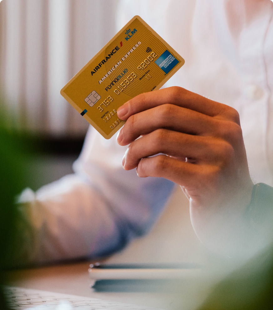 Man holding up a golf Airfrance American Express Credit Card