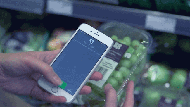 A man scans a QR code on some produce on their mobile phone