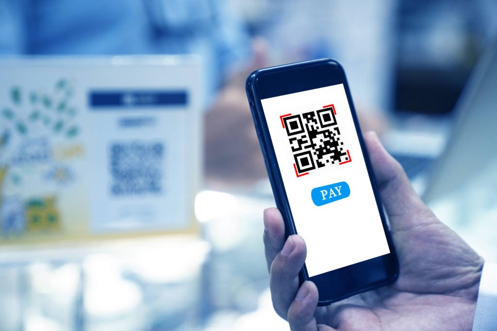 A person uses a QR code to pay wirelessly. 