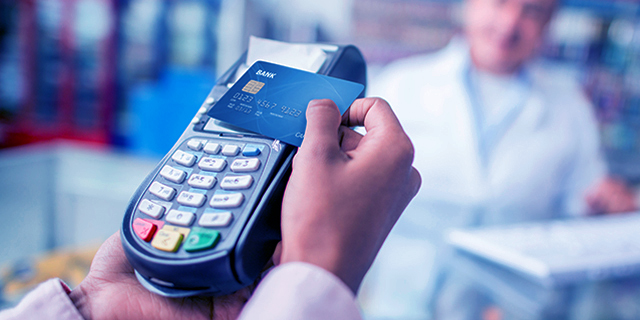 Client making a wireless payment on a card machine at a store