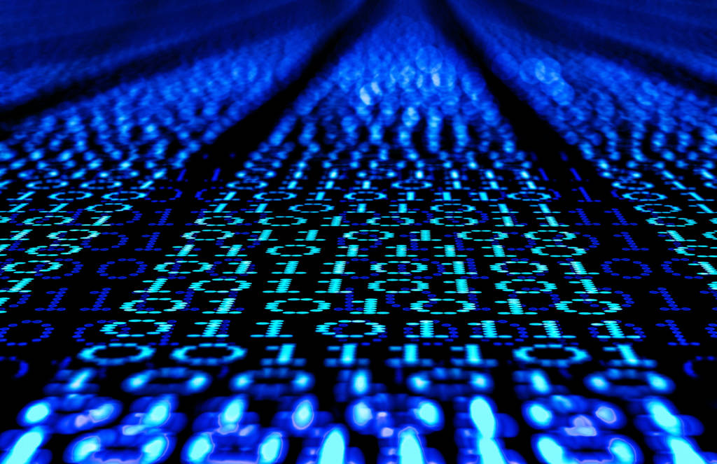 Binary code, ones and zeros in a 1970 dot matrix font on a computer screen. An infinity and lens bokeh effect applied.