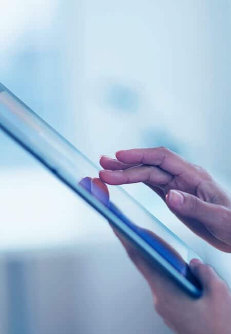 A woman is browsing on a tablet.
