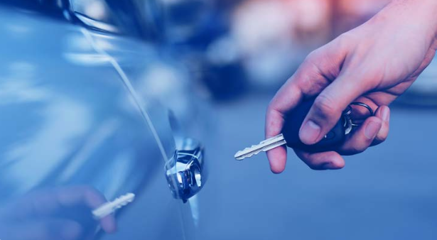 A hand unlocking a vehicle door