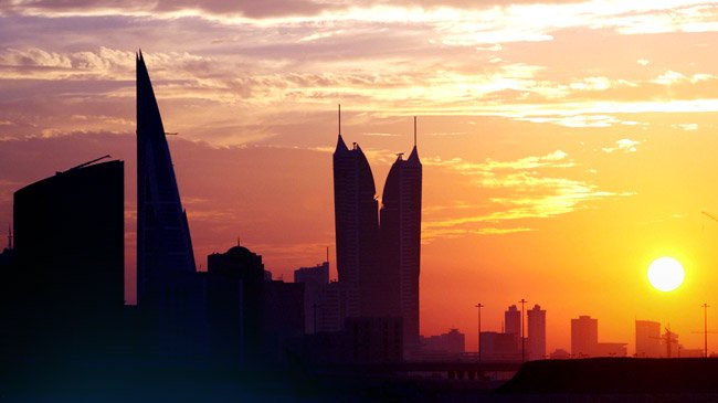 Shadow of a cityscape with a yellow and orange sunset