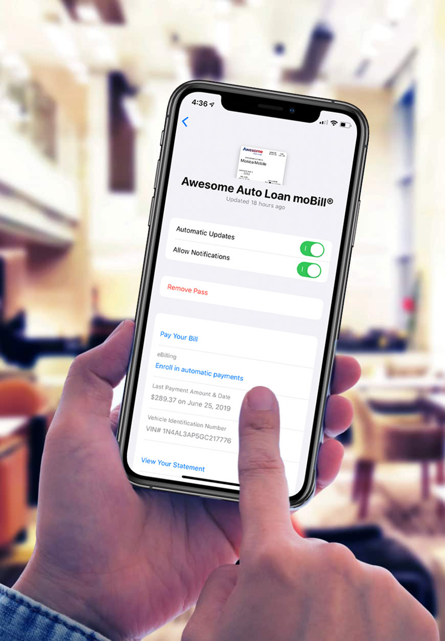 A person uses their phone to scan a QR code to pay their bill.