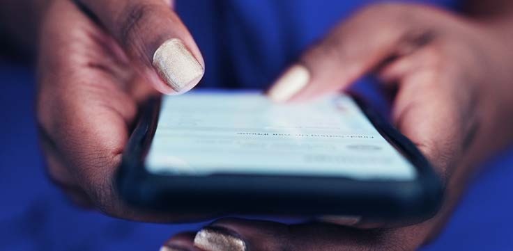 Woman types on her smartphone