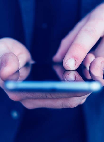 Business man holding smartphone and touching screen