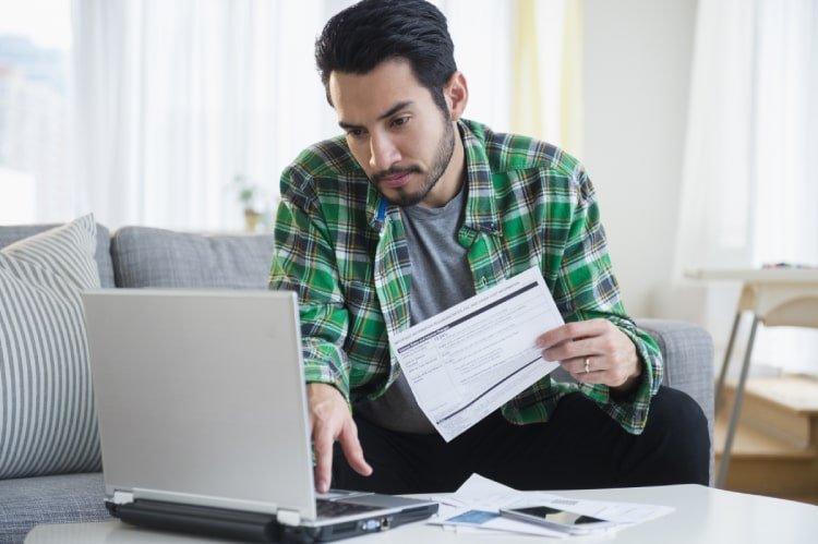 Man paying bill on computer