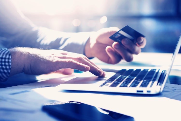 Man making online payment with his credit card