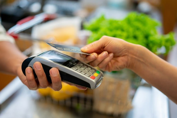 Customer making in-store payment using tap card