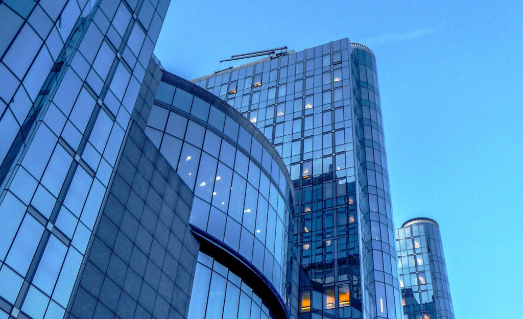 Low Angle View Of Modern Buildings Against Clear Blue Sky