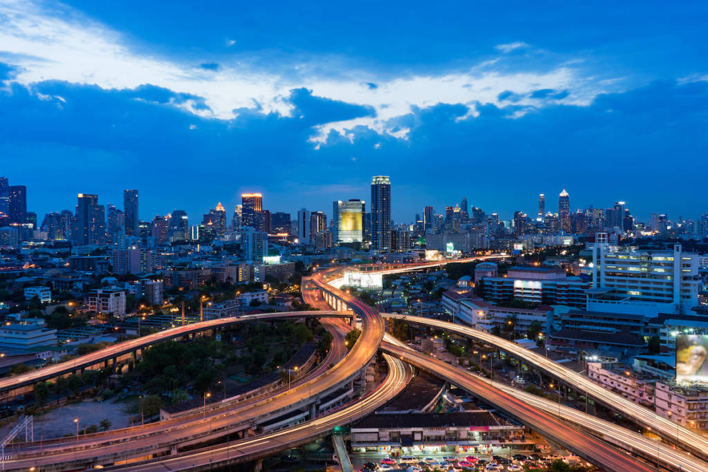 Sunset scene of cityscape with blue sky and clouds.