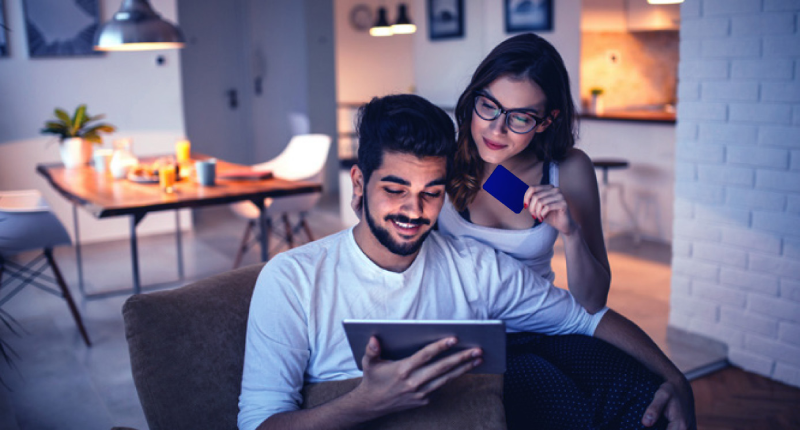 couple paying bills with card