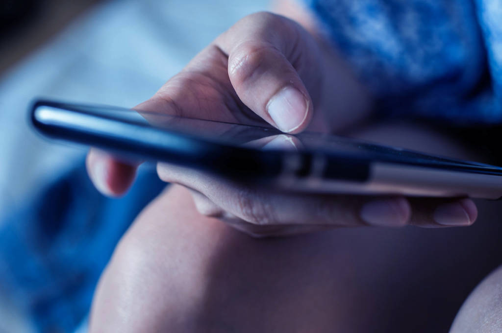 A woman is using a mobile phone