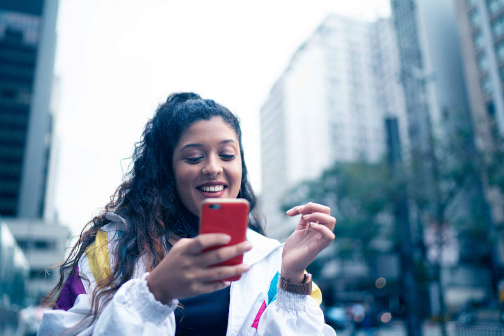 Woman using cellphone on street