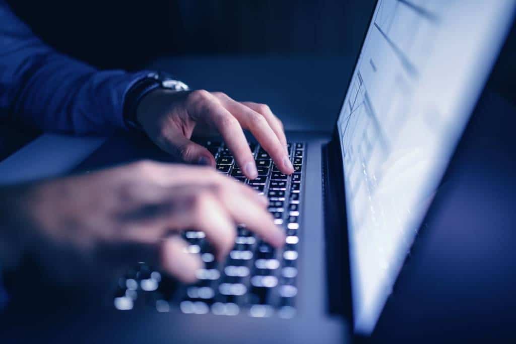 hands typing on a laptop