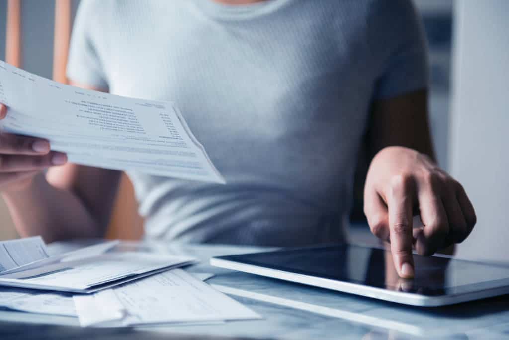 Woman paying bills with digital tablet