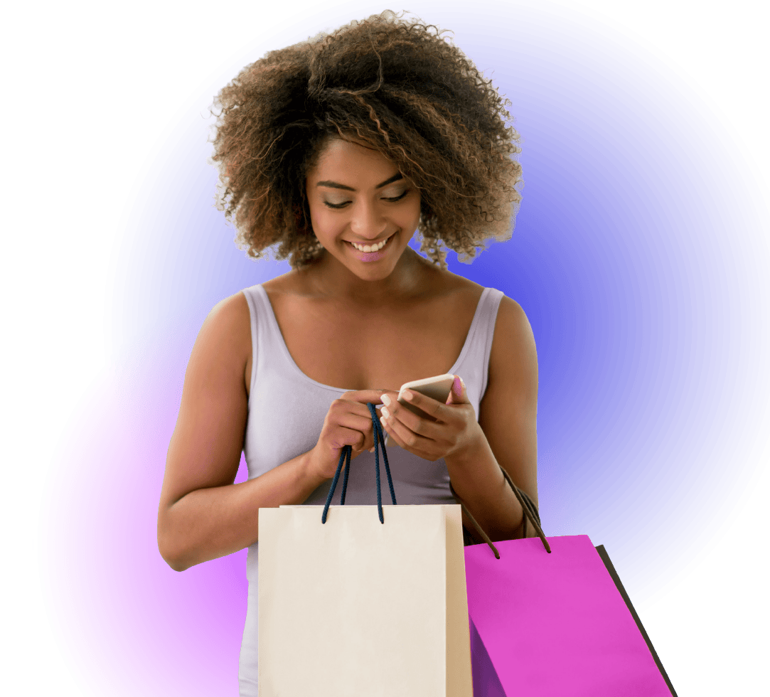 Young woman shopping, looking at her phone with shopping bags.