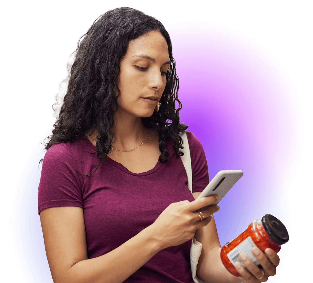 Businesswoman using smartphone with a pill bottle in hand, against a purple and blue background.
