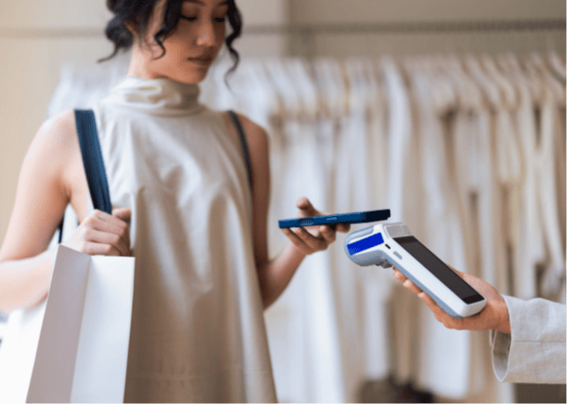 Customer making contactless payment with a card at a retail store.